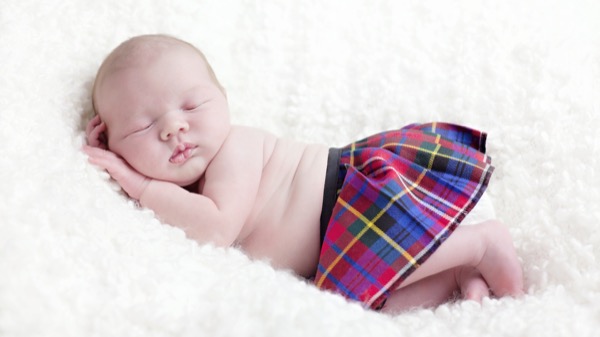 A sleeping ‘Bairn’ wearing a kilt – the Scottish name for a child